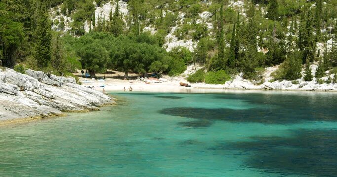 Beautiful landscape with green forest and emerald water lagoon of Foki Fiskardo beach, Kefalonia, Ionian islands, Greece.
