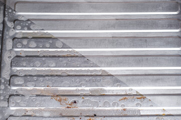 Detergent action as exemplified by an iron shiny ribbed surface