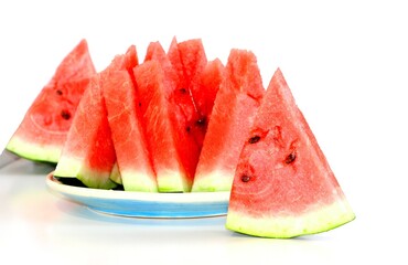 Pieces of juicy ripe sweet natural watermelon on white. Useful vitamins in summer. Seasonal fruits...