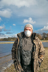 Naklejka premium photo with a portrait of a man, on the face is a protective mask