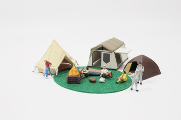 tiny people : travelers or backpackers walking on world map with camping