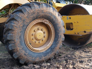 Large rubber wheels of the compactor. On the background, ground and metal wheels. Selective focus