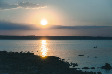 Beautiful twilight silhouette sunset on the Kuyalnik estuary near Odessa. Sunset over the lake. Evening sky with colorful cloud on twilight, Dusk