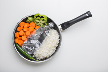 Plastic bottle as fish with vegetables on a pan