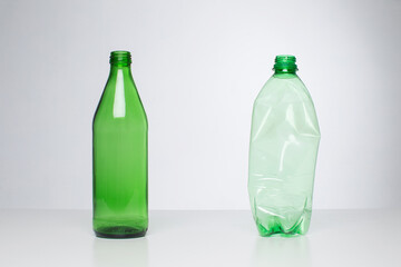 Glass bottle vs. plastic bottles, recycling concept