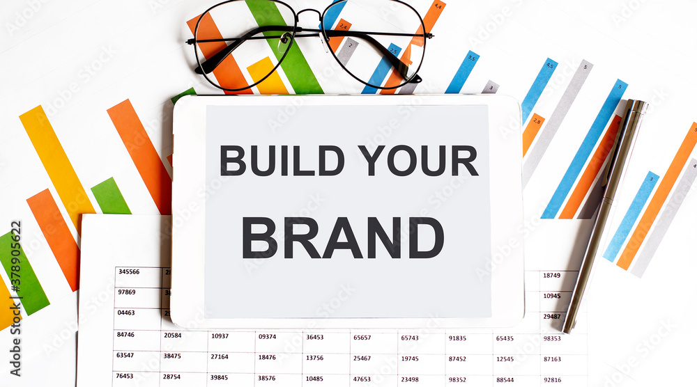 Poster the tablet with build your brand on a chart