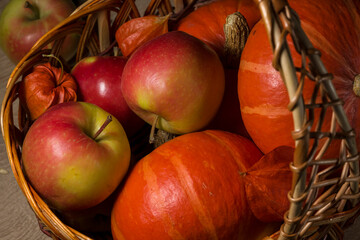 pumpkins and apples in a basket