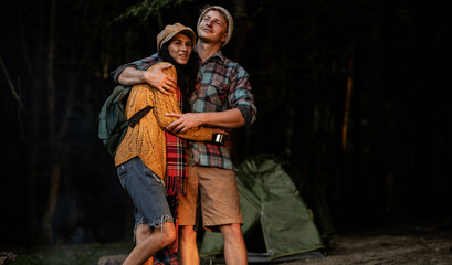 Portrait of happy young hipster couple in love. Camping couple. Forest background. Love. 