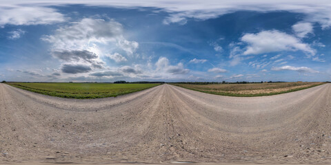 Full spherical seamless hdri panorama 360 degrees angle view on no traffic sand gravel road among fields with clear sky with beautiful clouds in equirectangular projection, VR AR content
