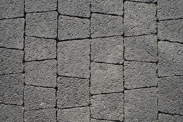 beautiful texture of paving stones from gray paving slabs of different sizes as a background