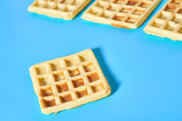 Vanilla belgian waffles on blue background