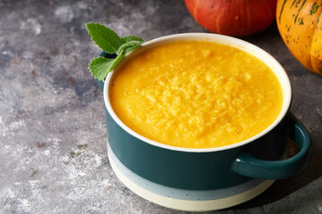 Traditional pumpkin soup puree in a bowl, on a dark background