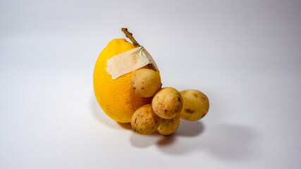 Two contrasting fruits taped together