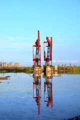 Oil pump under the blue sky, beam pumping unit in the oil field