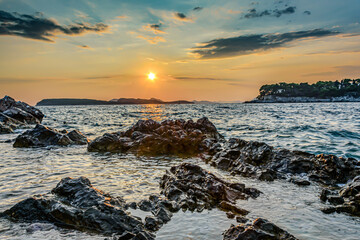 Sunset over rocky beach