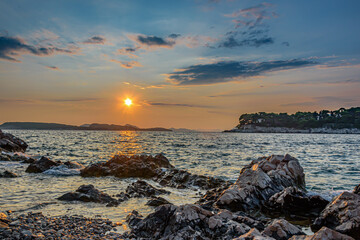 Sunset over rocky beach