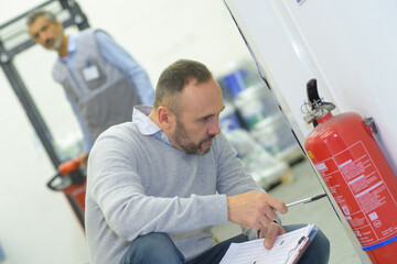 a professional checking fire extinguisher