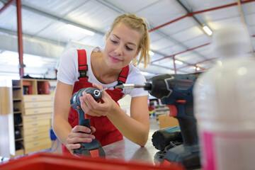 a female carpenter is woodworking