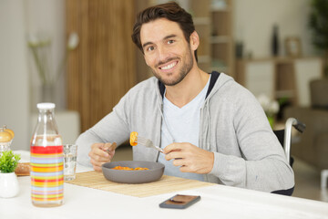 disabled young man husband working in kitchen