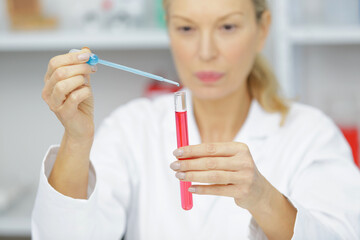 senior woman medical researcher in busy lab