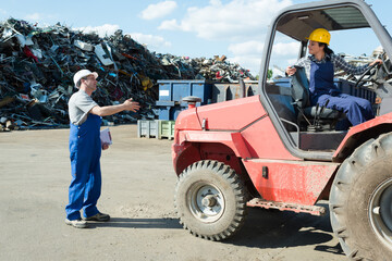 junkyard worker driving a truck