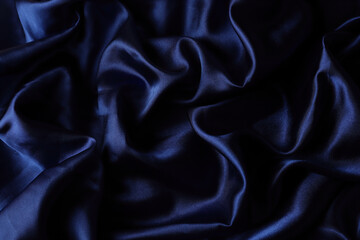 Fototapeta premium Blue glossy shiny material. Fabric texture. Drapery.