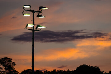 Lights in football stadion in the evening sunset
