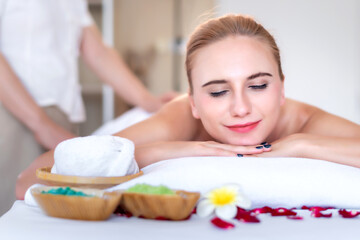 Obraz na płótnie Canvas Beautiful young attractive Caucasian woman having body massage by Thai Masseur in spa salon. Beauty treatment and body care lifestyle concept