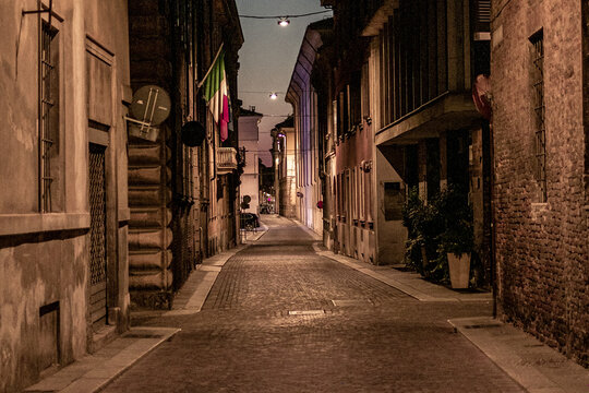 A street in Piacenza (Italy) without people, with the Italian flag hanging during the covid-19