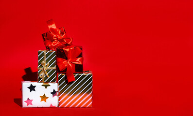 Boxes with New Year's gifts on red background with space for text, concept of new year card