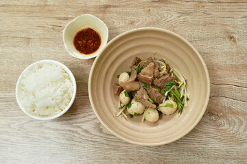 dry braised pork and ball with bean sprout  on bowl dipping spicy sauce eat couple plain rice