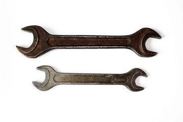 Old rusty wrench isolated on a white background.