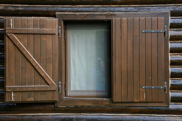 brown wooden shutters at a cottage