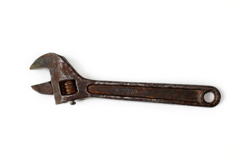 Old rusty adjustable spanner isolated on a white background.
