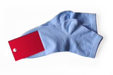New thin blue socks with a label isolated on white background.