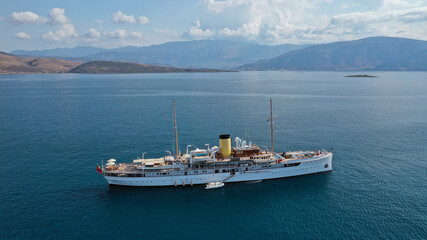 Aerial drone photo of classic wooden yacht anchored in Mediterranean bay with deep blue sea