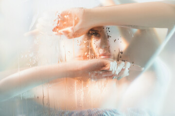 Art portrait. Feminine beauty. Double exposure blur sensual pensive woman silhouette with stained...
