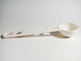 White plastic spoon background.