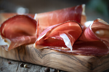 Italian prosciutto or jamon with rosemary, raw ham - obrazy, fototapety, plakaty