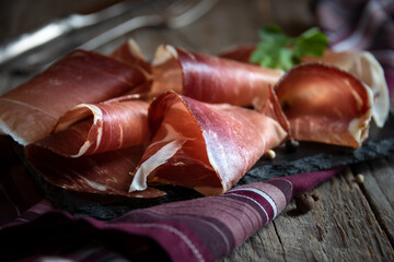 Italian prosciutto or jamon with rosemary, raw ham