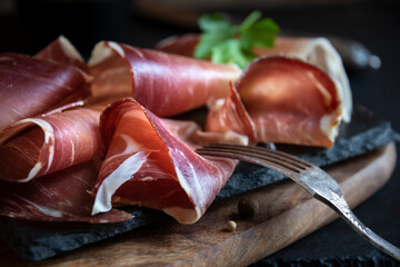 Italian prosciutto or jamon with rosemary, raw ham