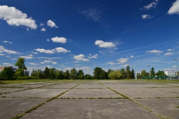 Concrete sports area. A grassy sports area of the school playground. Ready for sports. Background...