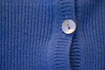 close up of blue cashmere clothes with buttons