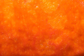 Orange background with pumpkin peel in soft focus.