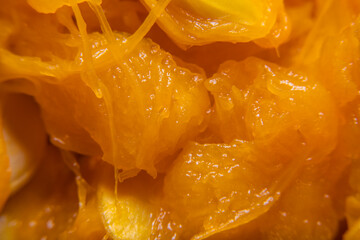 Background with close-up of pumpkin pulp and seeds inside in soft focus