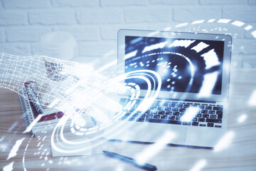 Double exposure of desktop computer and technology theme hologram. Concept of software development.