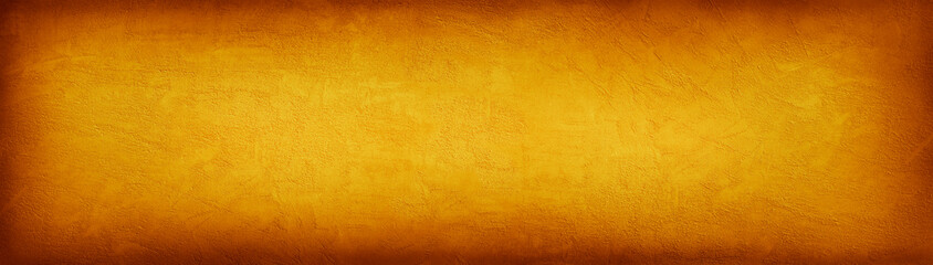 Abstract orange yellow background. Grunge. Toned concrete wall surface texture. Autumn concept. Wide banner. Copy space.