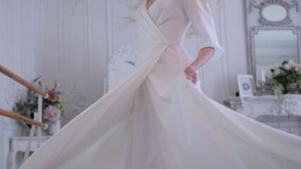 Fototapeta na wymiar Beautiful elegant bride in a simple white wedding dress