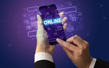 Female hand typing on smartphone with ONLINE inscription, social media concept