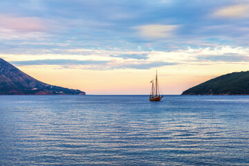 Fototapeta na wymiar Lonely ship in the harbour of Budva, Montenegro, sunset view